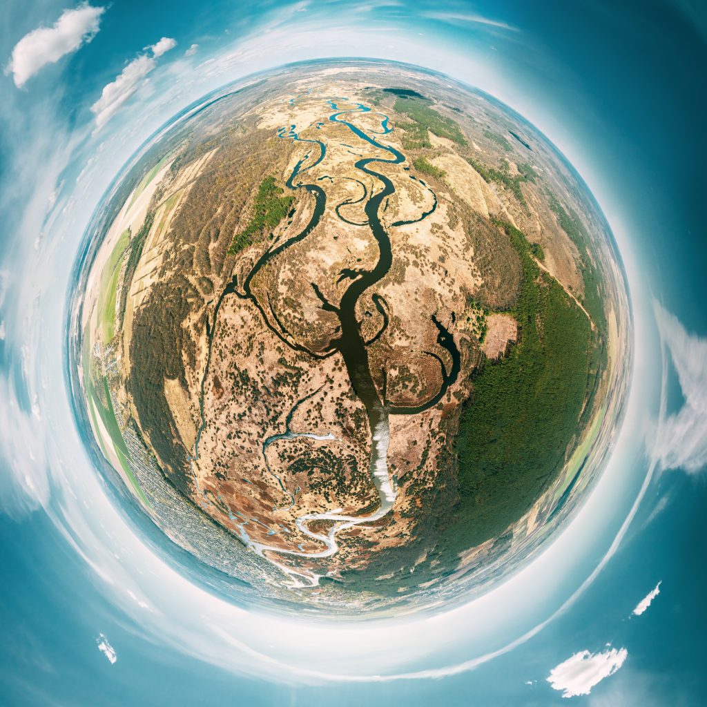 Aerial view of the Earth showing dense, lush greenery and vibrant forests.