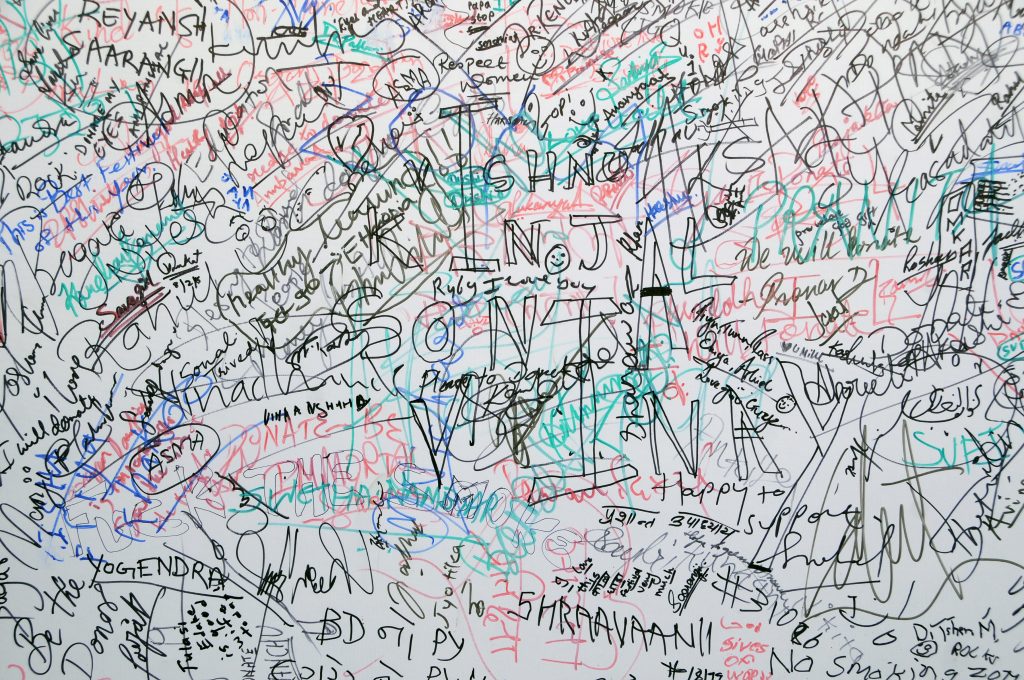 Crowded dry erase board filled with diagrams, notes, and ideas for brainstorming and essay writing
